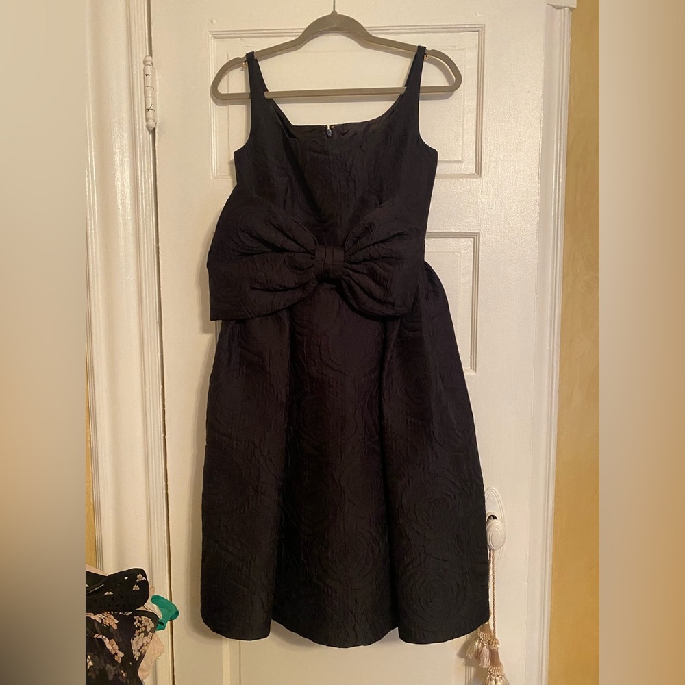 Kate Spade Black cocktail dress with signature bow and pockets.